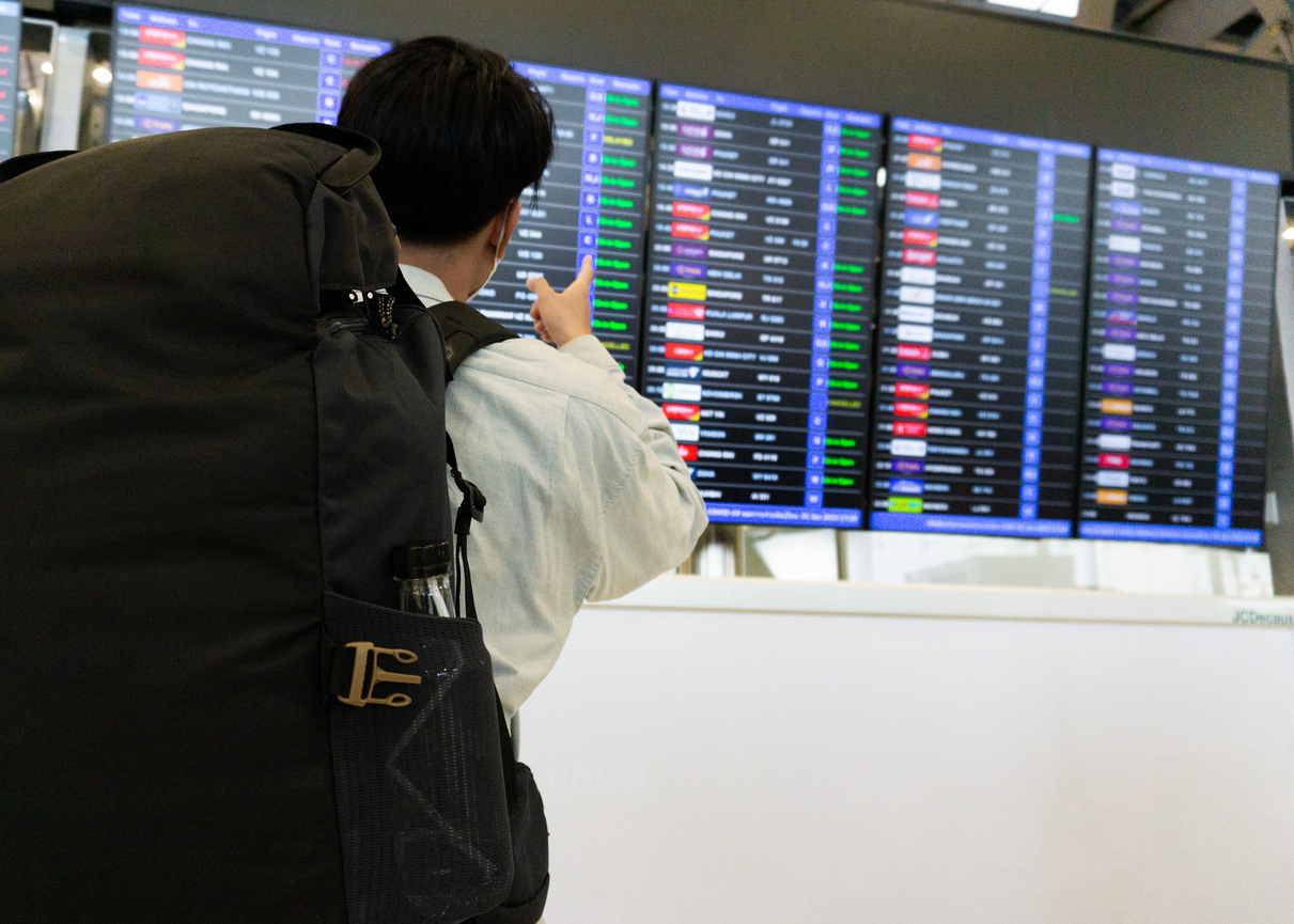 Traveler looking at a departure flight board.