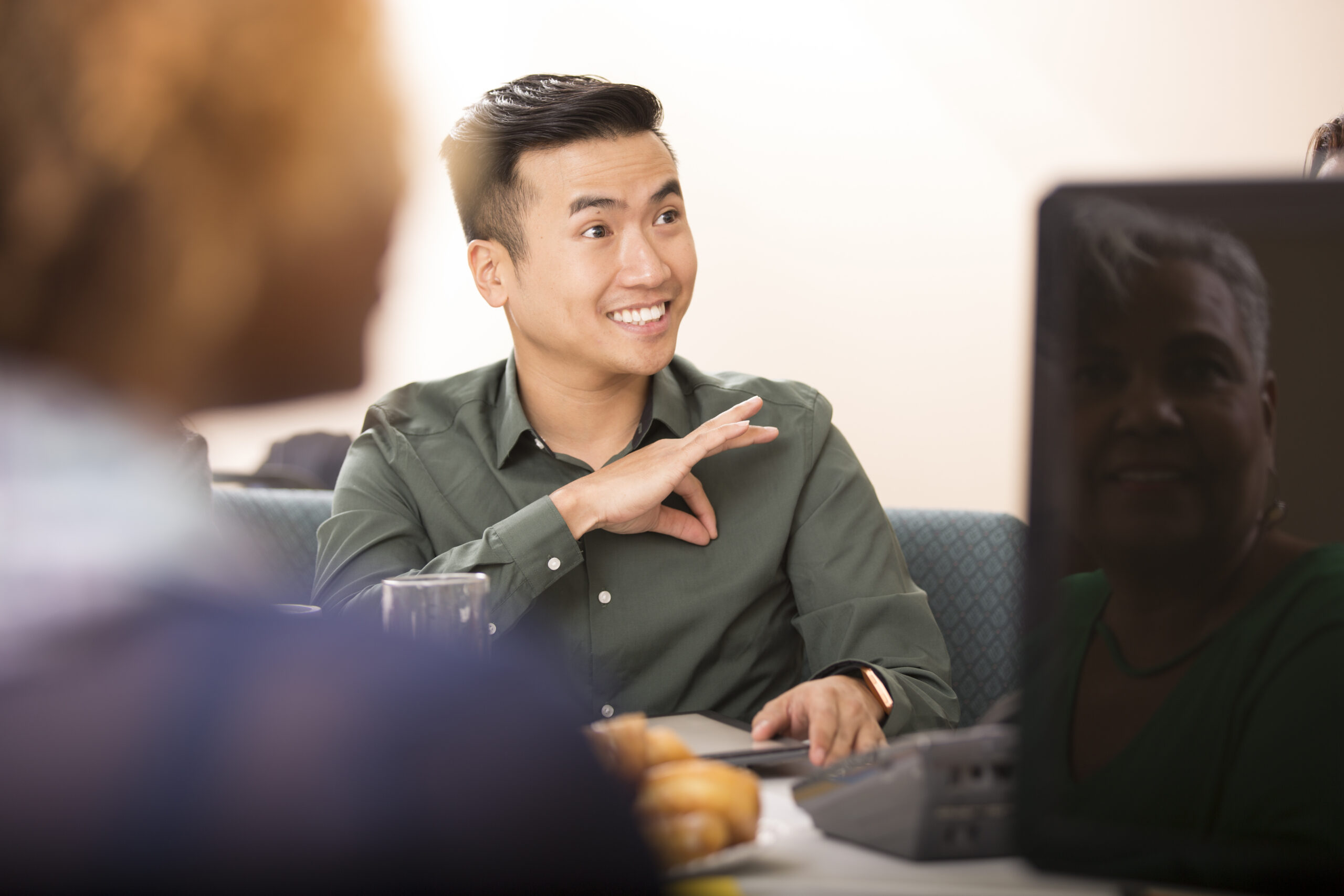 Man signs during meeting.