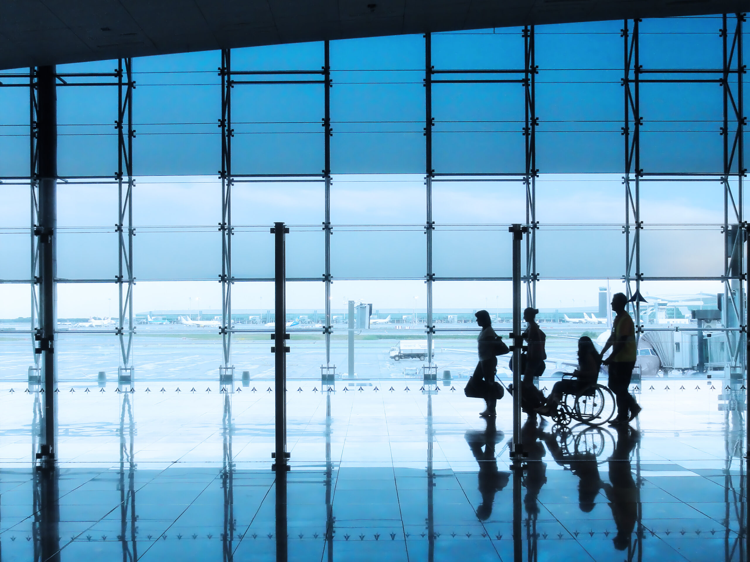 Passengers walking through airport.