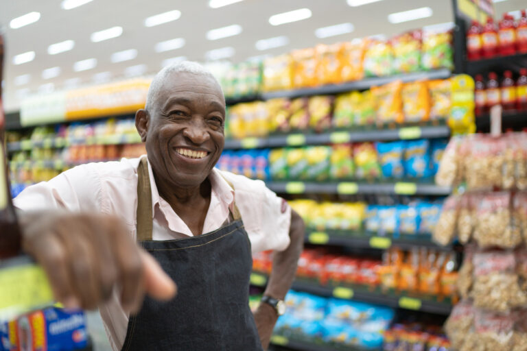 a person in a grocery store pointing at something