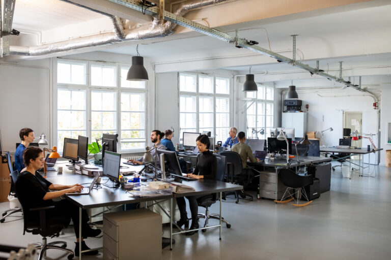 Casually dressed workers in a busy open plan office. Business people working at a modern office.